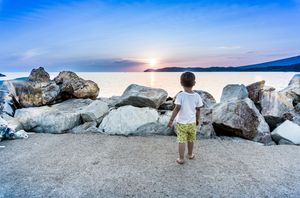 A child looking at the sea